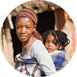 Young lady carrying a child on her back in Africa